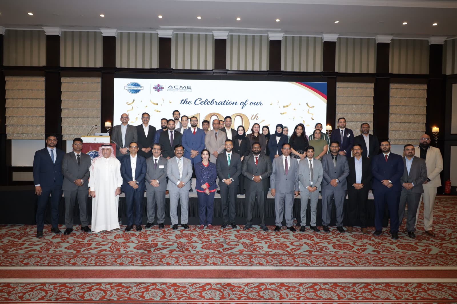 ACME Toastmasters Club members and guests celebrating the 100th meeting at the InterContinental Bahrain